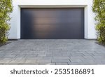 Modern Dark Garage Door with Paved Driveway