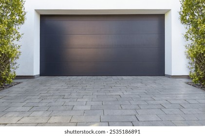 Modern Dark Garage Door with Paved Driveway - Powered by Shutterstock