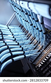 Modern data center with organized server racks and intricate network cable connections supporting efficient data processing and digital communication systems.