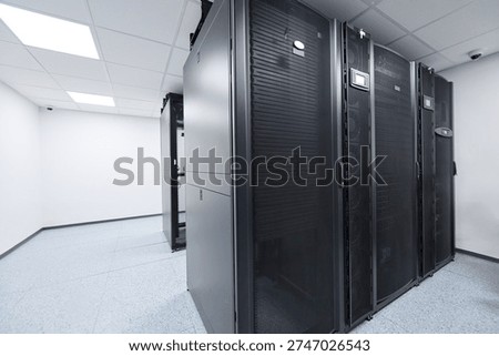 Modern data center server racks in a clean, climate-controlled server room for enterprise IT infrastructure