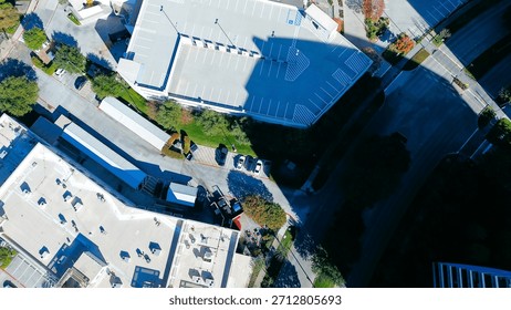 Modern deck parking multistory structure in Plano corporate campus, landscaped streets, autumn foliage, industrial rooftop HVAC units, modern business park planning, architectural diversity, TX. USA