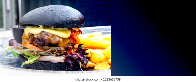 Modern Delicious Black Burger With Meat, Bun, Lettuce, Cheese, Ketchup. Funk Food Concept. Banner With Copy Space. Banner