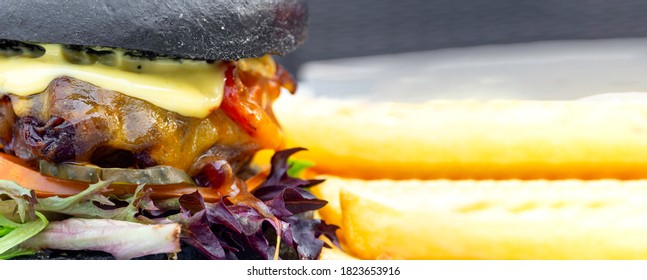 Modern Delicious Black Burger With Meat, Bun, Lettuce, Cheese, Ketchup Funk Food Concept. Banner With Copy Space. Banner