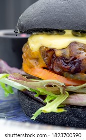 Modern Delicious Black Burger With Meat, Bun, Lettuce, Cheese, Ketchup. Funk Food Concept