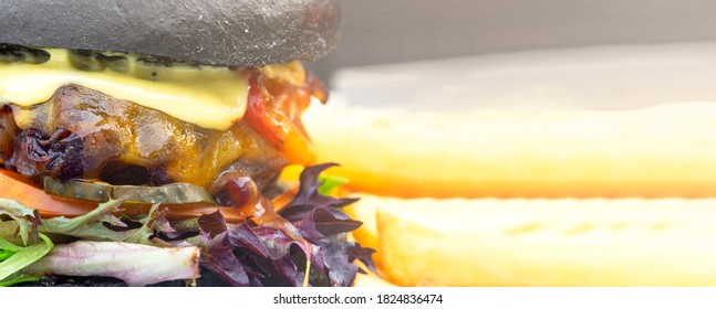 Modern Delicious Black Burger With Meat, Bun, Lettuce, Cheese, Ketchup. Funk Food Concept. Banner With Copy Space