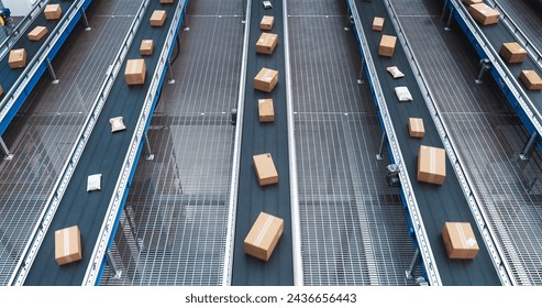 Modern Delivery Logistics Warehouse with Working Automated Conveyor Belt with Retail Parcels, Cardboard Boxes and Online Shopping Orders Being Prepared for Shipping - Powered by Shutterstock