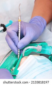 Modern Dental Clinic. Treatment Of Caries In A Child. General Anesthesia. Breathing Tube. Macro Photography. The Concept Of Healthcare. Vertical Photo.Unrecognizable Persons.