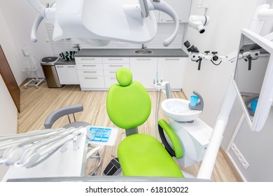 Modern Dental Office With Green Chair And Professional Computer Anesthesia System