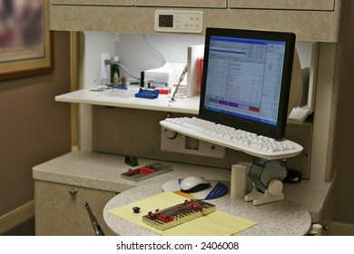 Modern Dentist Office With The Are Hygienist's Station And Equipment Ready For A Patient. The Billing System Is Showing On The Computer Monitor.