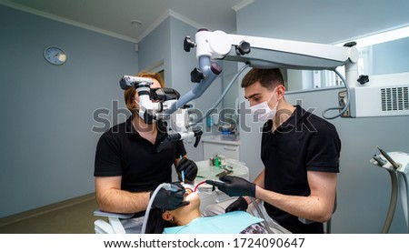 Modern dentistry office interior with chair and tools. Microscope in stomatology. Dentistry, medicine, medical equipment and stomatology concept. [[stock_photo]] © 