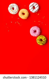 Modern design with bright donuts on red background top view mock up - Shutterstock ID 1381124510