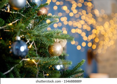 Modern design Christmas tree decorated with balls and garlands - navy blue, brown, beige. Winter holidays composition. Close up