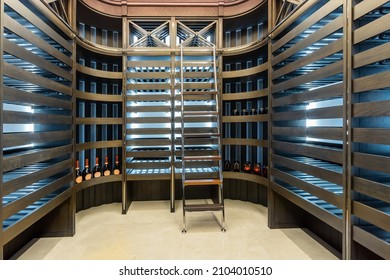 Modern Design Of A Home Wine Cellar With Shelves In The Rack And A Convenient Stepladder.