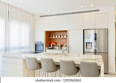 Modern Design Of Luxury White Kitchen With Marble Island And Dinner Table