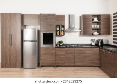 a modern design Modular Kitchen cabinet, stainless steel refrigerator with drawers and brown melamine cabinets