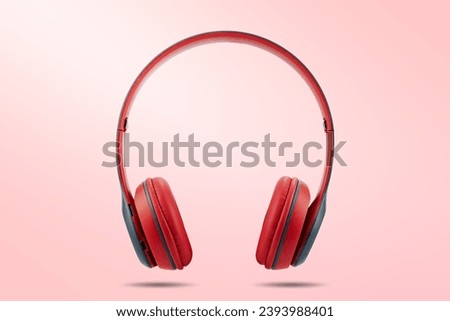 Modern design of red color wireless earphone isolated on pink color pastel background.