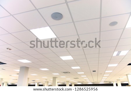 Modern design white office ceiling with white tiles and lighting Imagine de stoc © 
