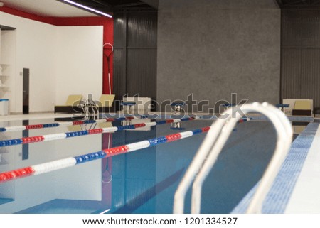 Modern designed professional swimming pool with clean water and divides. Recreation modern swimming pool. 