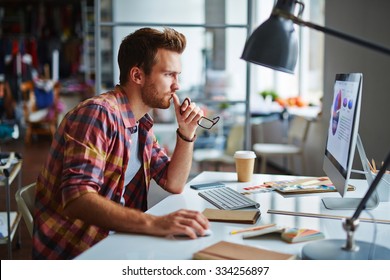 Modern Designer Sitting In Front Of Computer In Office