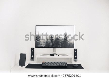Modern desktop computer with a white table in an office interior, concept of work space. Minimalist Setup