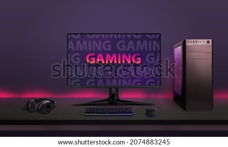 Modern desktop gaming setup on desk with led lights in background. Modern gaming font concept on computer display
