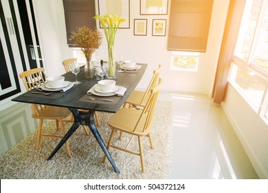 Modern Dining Room Interior With Warm Light From The Sun. Relax Day In Dining Room On Free Day And No Activity. Family Time With Food And Enjoy In The Family. Dining Room With Table And Spoon Set.