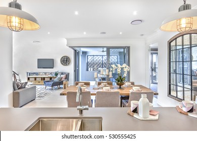 Modern Dining Room With Kitchen Counter Top And Living Room In The Middle Of The House