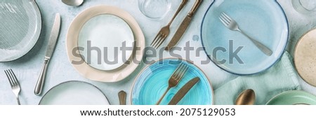 Modern dinnerware panorama with cutlery and various dishes, overhead flat lay shot, panoramic banner