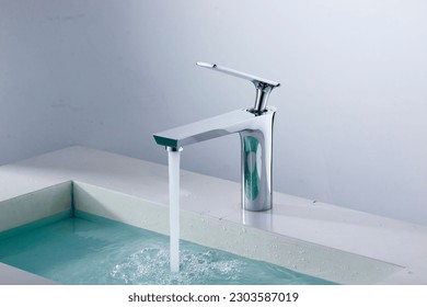Modern Domestic Bathroom with Faucets. A domestic bathroom featuring a sink, faucet, and bathtub surrounded by household equipment. Water Tap. - Shutterstock ID 2303587019
