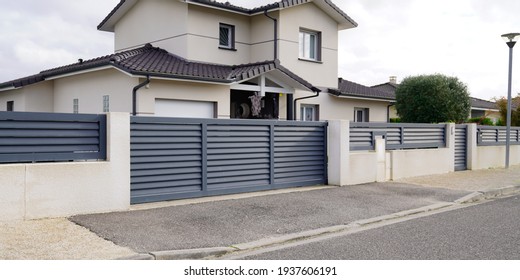 modern door gate of white two storey house driveway entrance gates home access garage in suburb - Shutterstock ID 1937606191