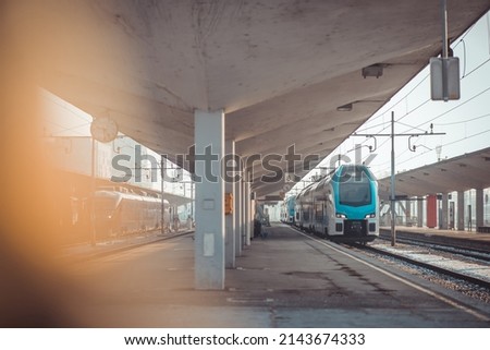Modern double decker train is standing in the city centre in Ljubljana railway station on morning of a cold winter day.
