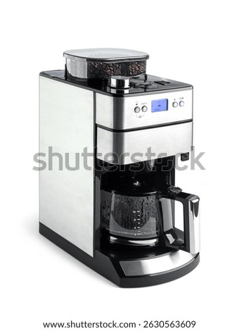 Modern drip coffee maker with built-in grinder, isolated on white background. Glass carafe, digital display, and stainless steel design. File contains a path to isolation.