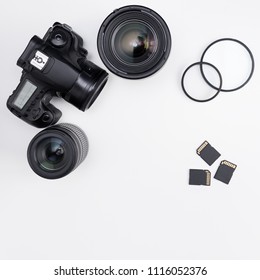 modern dslr camera, lenses, photo equipment and copy space over white table background - Powered by Shutterstock