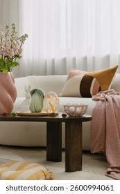 Modern Easter decorations with a touch of rustic charm. Woven bunny figurines, pastel pillows, and natural elements create a cozy holiday vibe.