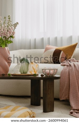 Modern Easter decorations with a touch of rustic charm. Woven bunny figurines, pastel pillows, and natural elements create a cozy holiday vibe.
