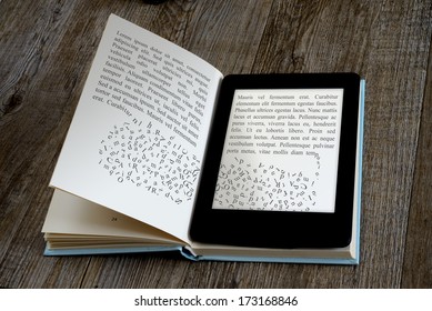 modern ebook reader on book on wooden background