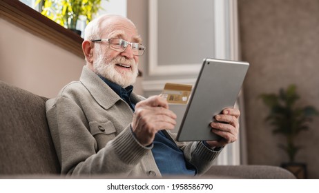 Modern elderly man grandfather shopping online with tablet and credit card at home. Senior grandpa e-shopping with digital tablet. Old man paying bills online. - Powered by Shutterstock