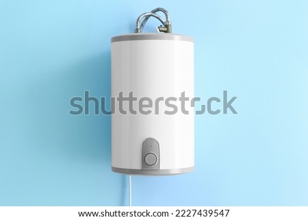 Modern electric boiler on blue wall