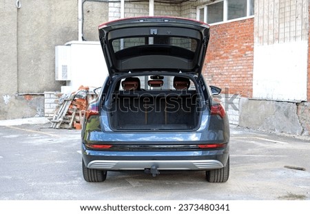 Modern electric car with open empty trunk. Modern electric SUV car open trunk. Car boot is open.