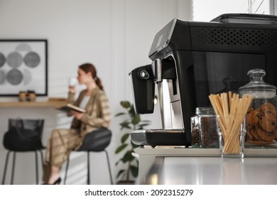 Modern Electric Coffee Machine On Table In Office. Space For Text