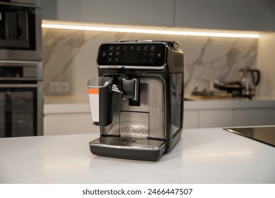 Modern electric espresso machine on white marble countertop in kitchen - Powered by Shutterstock