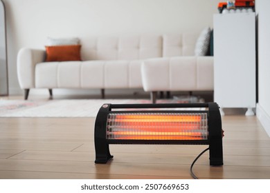 Modern electric infrared heater in living room, closeup