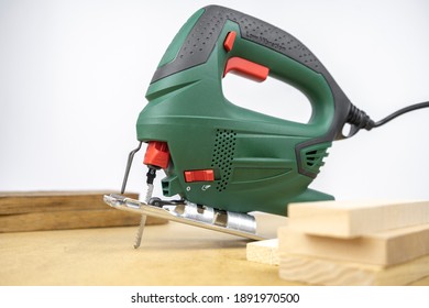 Modern Electric Jig Saw Tool For DIY Home Woodworking. Wood Boards On Background