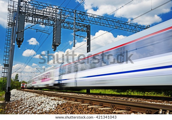 Modern\
electric passenger train moving on full\
speed.