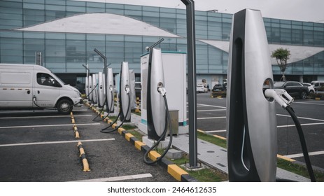 Modern Electric Vehicle Charging Stations at Urban Parking Lot - Powered by Shutterstock