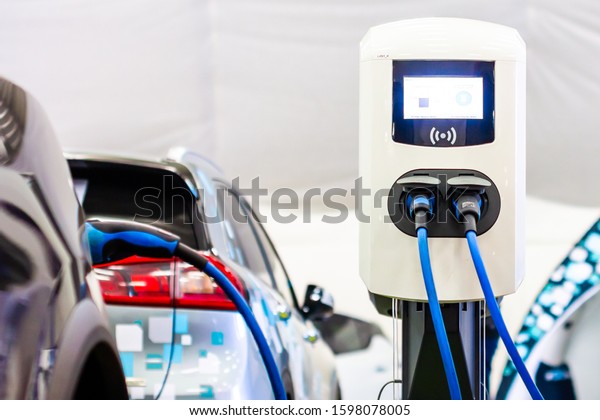 A modern\
electrical fast charger for the electrical or hybrid PHEV\
automobiles. An Energy power of future. Ecology friendly charger\
concept. Home electric car battery\
charger.