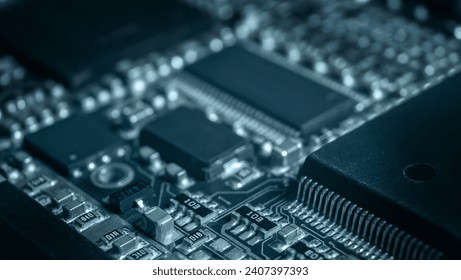 Modern electronic circuit board with processor, integrated circuits and surface mounted passive components close up. Technology background