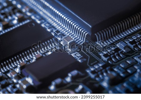 Modern electronic circuit board with processor, integrated circuits and surface mounted passive components close up. Technology background