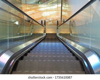 The modern electronic Escalator is moving down in the building.