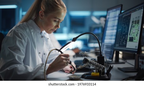 Modern Electronics Research and Development Facility: Beautiful Caucasian Female Engineer Does Computer Motherboard Soldering. Scientists Design Industrial PCB, Silicon Microchips, Semiconductors - Powered by Shutterstock